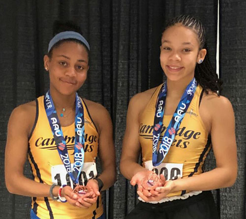 Two athletes hold medals