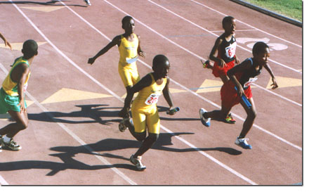 Boys passing off baton in relay
