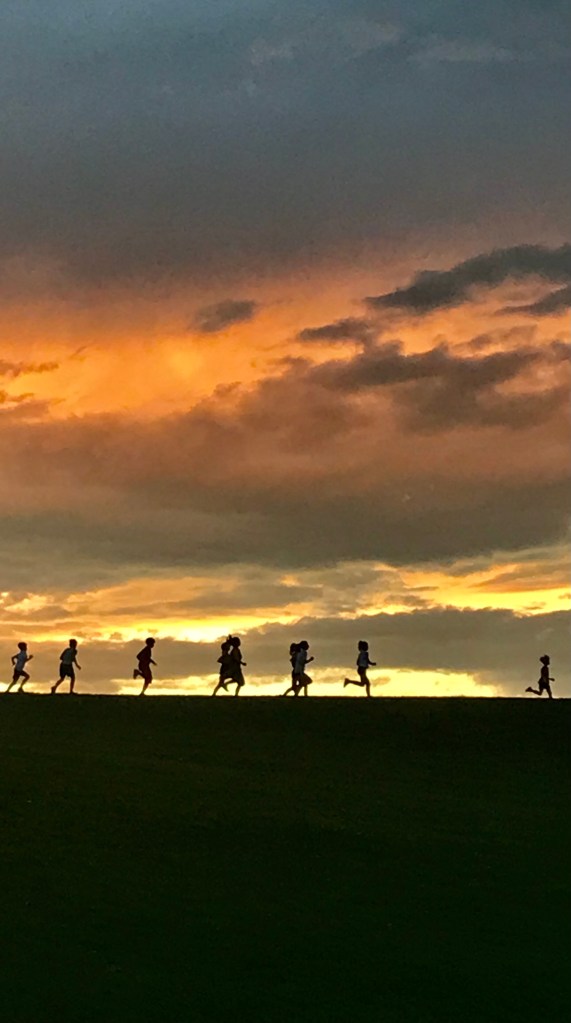 Kids running up hill at practice